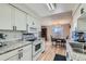 Bright kitchen featuring white cabinets, modern appliances, granite countertops and hardwood flooring at 9943 Croke Dr, Denver, CO 80260