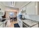 Bright kitchen with stainless appliances, granite countertops, and white cabinetry at 9943 Croke Dr, Denver, CO 80260