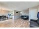 Spacious living room featuring hardwood floors and an open layout connected to dining area and kitchen at 9943 Croke Dr, Denver, CO 80260