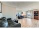 Bright living room featuring wood floors, neutral walls, sliding glass door, and comfortable seating at 9943 Croke Dr, Denver, CO 80260