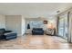 Bright living room featuring wood floors, neutral walls, sliding glass door, and comfortable seating at 9943 Croke Dr, Denver, CO 80260