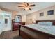 Comfortable main bedroom featuring a ceiling fan, dresser with mirror, and a king-size bed at 9943 Croke Dr, Denver, CO 80260