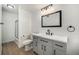 Clean bathroom featuring grey vanity, modern fixtures, and a shower with glass door at 16259 W 10Th Ave # K-3, Golden, CO 80401