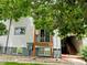 Exterior view of property with a balcony, surrounded by mature trees and greenery at 16259 W 10Th Ave # K-3, Golden, CO 80401