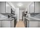 Modern kitchen featuring stainless steel appliances, grey cabinets, and granite countertops at 16259 W 10Th Ave # K-3, Golden, CO 80401
