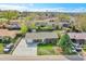 This aerial view shows a house with a driveway and front lawn at 8353 Adams Way, Denver, CO 80221