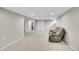 Finished basement with neutral carpet, recessed lighting, and a comfortable leather recliner at 8353 Adams Way, Denver, CO 80221