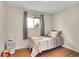 Comfortable bedroom with hardwood floors, natural light from window, and neutral walls at 8353 Adams Way, Denver, CO 80221