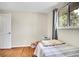 Cozy bedroom with hardwood floors, a window for natural light, and neutral walls at 8353 Adams Way, Denver, CO 80221