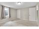 This bedroom offers a carpeted floor, a window and a closet at 8353 Adams Way, Denver, CO 80221