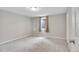 Well-lit bedroom with neutral carpet, window, and a closet at 8353 Adams Way, Denver, CO 80221