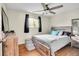 Comfortable bedroom with hardwood floors, window, and gray bedding at 8353 Adams Way, Denver, CO 80221