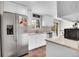 Bright kitchen featuring stainless steel appliances, white cabinets, and modern countertops at 8353 Adams Way, Denver, CO 80221
