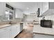 Well-lit kitchen featuring white cabinets, modern countertops, and stainless steel appliances at 8353 Adams Way, Denver, CO 80221
