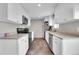 Bright kitchen with white cabinetry, tile flooring, stainless steel appliances, and granite countertops at 8353 Adams Way, Denver, CO 80221