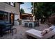 Outdoor kitchen and dining area with stone accents, a grill, bar seating, and lounge space at 3812 W 24Th Ave, Denver, CO 80211