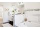 Bright bathroom with marble tiling, double vanity, and a relaxing bathtub at 3812 W 24Th Ave, Denver, CO 80211