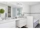 Modern bathroom featuring double sinks, a large mirror, and a glass-enclosed shower and bathtub at 3812 W 24Th Ave, Denver, CO 80211