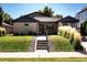 Inviting home features a well-kept lawn, decorative grasses, and a welcoming entrance at 3812 W 24Th Ave, Denver, CO 80211