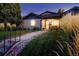 Charming home with a landscaped front yard, walkway, and well-lit exterior at 3812 W 24Th Ave, Denver, CO 80211