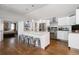 Modern kitchen featuring stainless steel appliances, an island with seating, and hardwood floors at 3812 W 24Th Ave, Denver, CO 80211