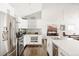 Bright kitchen with stainless steel appliances, quartz countertops, and hardwood flooring at 3812 W 24Th Ave, Denver, CO 80211