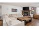 Comfortable living room features a stone fireplace, hardwood floors, and a large sectional sofa at 3812 W 24Th Ave, Denver, CO 80211