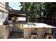 This covered outdoor kitchen features stone accents, stainless steel appliances, and a built-in bar area at 3812 W 24Th Ave, Denver, CO 80211
