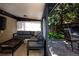 Covered patio with a sectional sofa, coffee table, and access to the backyard at 3812 W 24Th Ave, Denver, CO 80211