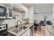 Modern kitchen features granite countertops and updated cabinetry at 5995 E Iliff Ave # 120, Denver, CO 80222