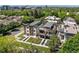 Aerial shot showcasing modern homes with rooftop decks, green lawns, and a cityscape backdrop at 417 N Madison St, Denver, CO 80206