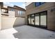 Contemporary home featuring a concrete patio and expansive black-framed glass doors leading to the interior at 417 N Madison St, Denver, CO 80206