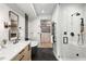 Luxurious bathroom with a glass shower, a soaking tub, and an adjacent walk-in closet at 417 N Madison St, Denver, CO 80206