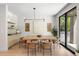 Dining area with modern lighting fixture, a wooden table and four chairs at 417 N Madison St, Denver, CO 80206