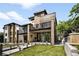 Modern home with a well-manicured lawn, private balconies, and a stylish brick and wood facade at 417 N Madison St, Denver, CO 80206