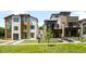 Side-by-side modern homes with manicured lawns, sleek designs, and fenced yards on a sunny day at 417 N Madison St, Denver, CO 80206