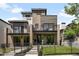 Modern, two-story home showcasing a unique facade with a mix of brick and wooden finishes and small front yard at 417 N Madison St, Denver, CO 80206
