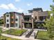 Pair of modern homes showcasing their stylish exteriors, green lawns, and contemporary design elements at 417 N Madison St, Denver, CO 80206