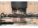 Close up of gourmet gas range with stylish tile backsplash and stainless hood among the sleek cabinets at 417 N Madison St, Denver, CO 80206