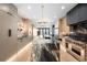 Bright, open kitchen featuring a marble island, stainless steel appliances, and modern pendant lighting fixtures at 417 N Madison St, Denver, CO 80206