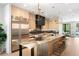 Modern kitchen with stainless steel appliances, a large island with seating, and black marble backsplash at 417 N Madison St, Denver, CO 80206