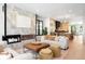 Open concept living room flowing into kitchen with fireplace, modern furniture, and lots of natural light at 417 N Madison St, Denver, CO 80206