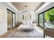 Bright main bedroom with a king bed, decorative rug, and balcony access at 417 N Madison St, Denver, CO 80206