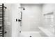 Bright shower with white subway tile, black hardware, and a built-in bench for a luxurious experience at 417 N Madison St, Denver, CO 80206