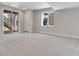 Spacious basement with a walkout to the exterior and light gray carpet at 6863 Oak Canyon Cir, Castle Pines, CO 80108