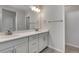 Modern bathroom with double vanity, large mirror, and contemporary lighting at 6863 Oak Canyon Cir, Castle Pines, CO 80108