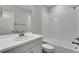 Bathroom featuring a vanity with modern fixtures and a shower-tub combo with white tile at 6863 Oak Canyon Cir, Castle Pines, CO 80108