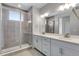 Modern bathroom with double vanity, glass shower, and contemporary fixtures at 6863 Oak Canyon Cir, Castle Pines, CO 80108