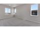 Bedroom with large windows and neutral carpet, offering plenty of natural light at 6863 Oak Canyon Cir, Castle Pines, CO 80108