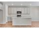 A modern kitchen featuring gray cabinets and a spacious kitchen island at 6863 Oak Canyon Cir, Castle Pines, CO 80108